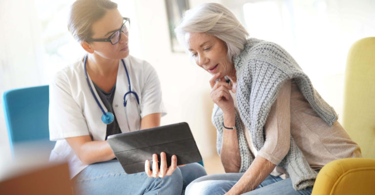 patient and healthcare provider looking at a tablet