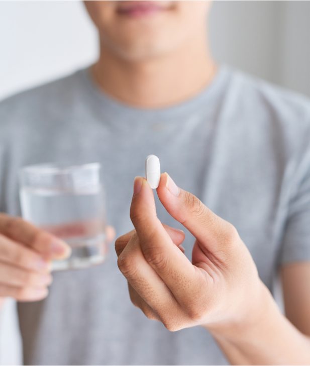 Patient holding a pill tablet